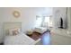 Cozy bedroom with two twin beds, white furniture, and wood-look flooring at 148 Brunello Dr, Davenport, FL 33897