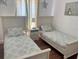Bright bedroom with two twin beds, and white furniture at 148 Brunello Dr, Davenport, FL 33897
