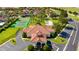 Community center with tile roof, parking lot, and adjacent tennis court at 148 Brunello Dr, Davenport, FL 33897