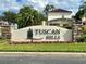 The Tuscan Hills community entrance sign with lush landscaping at 148 Brunello Dr, Davenport, FL 33897