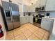 Spacious kitchen features stainless steel appliances, light green cabinets, and ample counter space at 148 Brunello Dr, Davenport, FL 33897