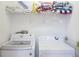 Laundry room with a stacked washer and dryer, and storage shelf at 148 Brunello Dr, Davenport, FL 33897