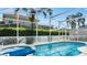 Private pool with spa, lounge chairs, and lush landscaping within screened enclosure at 148 Brunello Dr, Davenport, FL 33897