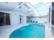 Screened-in pool with spa, lounge chairs, and view of home exterior at 148 Brunello Dr, Davenport, FL 33897