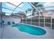 Spacious pool and spa with a screened enclosure and surrounding patio at 148 Brunello Dr, Davenport, FL 33897