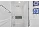 Spacious walk-in shower with white subway tile, glass door, and built-in bench at 148 Brunello Dr, Davenport, FL 33897