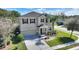 Two-story house with a two-car garage and landscaped lawn at 2056 Marabou Dr, Davenport, FL 33896