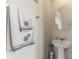 Small half bathroom with pedestal sink and mirror at 2056 Marabou Dr, Davenport, FL 33896