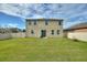 Spacious backyard with a large grassy area and a tall privacy fence at 2056 Marabou Dr, Davenport, FL 33896