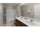 Bathroom with double vanity, tub, and shower at 2056 Marabou Dr, Davenport, FL 33896