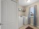 Bright laundry room with washer, dryer, and shelving at 2056 Marabou Dr, Davenport, FL 33896