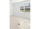 Bright bedroom with large window and tile floor at 27472 Black Kite Ave, Howey In The Hills, FL 34737