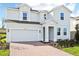 Two-story house with a gray exterior and brick driveway at 27472 Black Kite Ave, Howey In The Hills, FL 34737