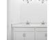 Double vanity bathroom with white cabinets and quartz countertop at 27472 Black Kite Ave, Howey In The Hills, FL 34737