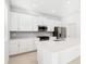 White kitchen with stainless steel appliances at 27472 Black Kite Ave, Howey In The Hills, FL 34737