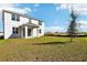 Two-story house with backyard, covered patio, and grassy area at 27472 Black Kite Ave, Howey In The Hills, FL 34737