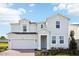 Two-story house with a gray exterior and brick driveway at 27472 Black Kite Ave, Howey In The Hills, FL 34737