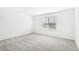 Simple bedroom with grey carpet and a large window at 27472 Black Kite Ave, Howey In The Hills, FL 34737