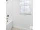 Bright bathroom with white subway tile, a bathtub, and window blinds at 27472 Black Kite Ave, Howey In The Hills, FL 34737