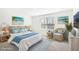 Virtually staged bedroom with wicker furniture and beach-themed decor at 27472 Black Kite Ave, Howey In The Hills, FL 34737