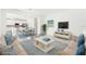Open living room and kitchen with coastal decor at 27472 Black Kite Ave, Howey In The Hills, FL 34737