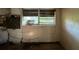 A damaged kitchen with broken window and exposed wires at 3814 Ne 5Th St, Ocala, FL 34470