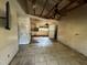 Living room with exposed ceiling beams and damaged flooring at 3814 Ne 5Th St, Ocala, FL 34470