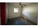 Small bedroom with window and ceiling fan needs updating at 3814 Ne 5Th St, Ocala, FL 34470