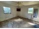 Empty bedroom with window and ceiling fan needs updating at 3814 Ne 5Th St, Ocala, FL 34470