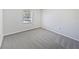 Simple bedroom with gray carpet and a window with blinds at 5119 Timber Ridge Trl, Ocoee, FL 34761