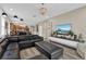 Open concept living room with sectional sofa and media console at 5364 Ragusa Loop, Saint Cloud, FL 34771