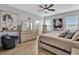 Main bedroom with ceiling fan and large windows at 5364 Ragusa Loop, Saint Cloud, FL 34771