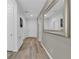 Clean hallway with light walls and mirror at 5364 Ragusa Loop, Saint Cloud, FL 34771