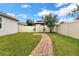 Landscaped backyard, gazebo, and brick pathway at 5364 Ragusa Loop, Saint Cloud, FL 34771