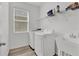 Bright laundry room, washer, dryer, utility sink, and shelving at 5364 Ragusa Loop, Saint Cloud, FL 34771