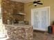 Outdoor kitchen with stone countertops, grill, and stainless steel appliances at 765 E Chapman Rd, Oviedo, FL 32765