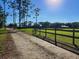 Long driveway leading to a charming house with a fenced yard at 765 E Chapman Rd, Oviedo, FL 32765