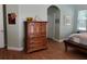 Main bedroom with wood dresser, light walls, and wood floors at 765 E Chapman Rd, Oviedo, FL 32765