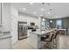 Modern kitchen with white cabinets, granite countertops, and stainless steel appliances at 811 Pebble Crest Ln, Eagle Lake, FL 33839
