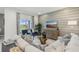 Bright living room with comfy seating, large TV, and sliding glass doors leading to the backyard at 811 Pebble Crest Ln, Eagle Lake, FL 33839