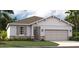 One-story house with gray siding and two-car garage at 811 Pebble Crest Ln, Eagle Lake, FL 33839