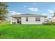 Home's back view, featuring a covered patio at 811 Pebble Crest Ln, Eagle Lake, FL 33839
