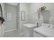 Well-appointed laundry room with washer, dryer, and ample shelving at 811 Pebble Crest Ln, Eagle Lake, FL 33839