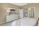 Bedroom with a dresser, king-size bed, and views into the kitchen at 811 Pebble Crest Ln, Eagle Lake, FL 33839