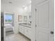 Main bathroom with double vanity and bedroom view at 811 Pebble Crest Ln, Eagle Lake, FL 33839