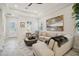 Living room with light beige sectional sofa and large abstract art at 8760 Shapley St, Orlando, FL 32827