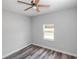 Simple bedroom with wood-look floors and a window at 8969 Sheppard Dr, Lake Wales, FL 33898