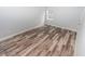 Spacious bedroom featuring wood-look floors and large window at 8969 Sheppard Dr, Lake Wales, FL 33898
