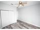 Bedroom with double door closet, wood-look floors, and ceiling fan at 8969 Sheppard Dr, Lake Wales, FL 33898