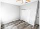 Bright bedroom featuring wood-look floors and double closets at 8969 Sheppard Dr, Lake Wales, FL 33898